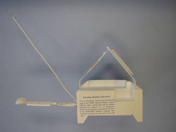 Fig. 4— Lockheed Martin LMS-6 radiosonde. Antenna on the left and the return envelope is located on the upper right tab.